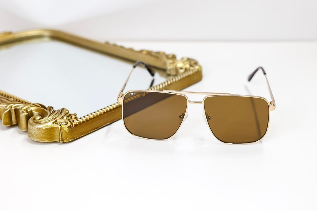 Gold-framed sunglasses on a white background