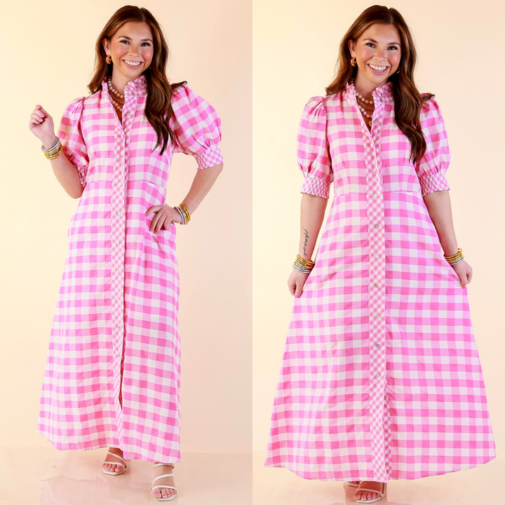 Model is wearing Gingham Print Midi Dress with Puff Sleeves and Checkered Trim in Pink against a beige backdrop. 
