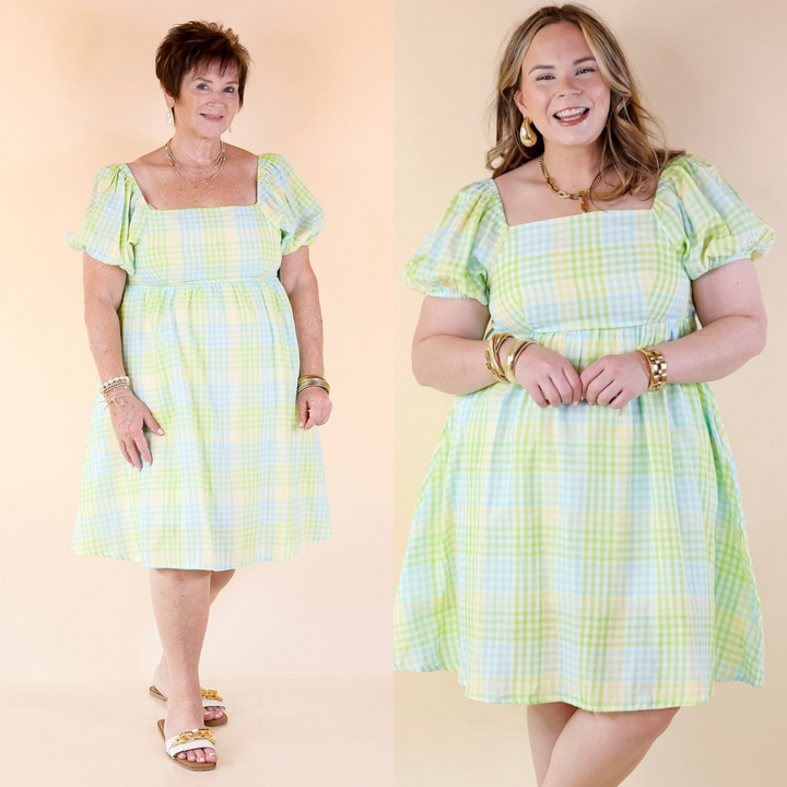 This dress features balloon sleeves, a square neckline, and hues of green, blue, and yellow. Available in sizes small to 3XL, and fully lined for your comfort.
