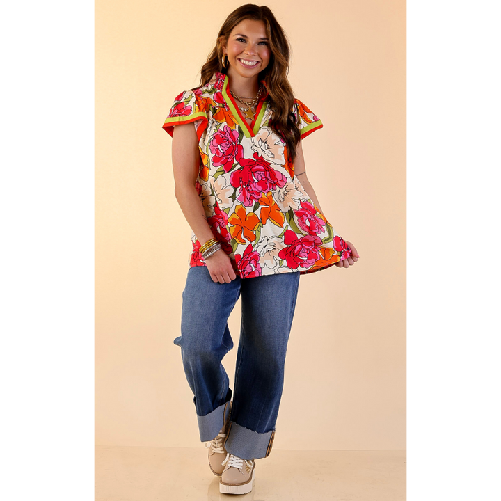 Spring Symphony Floral Print Flutter Sleeve Top with Contrast Trim Split Neckline in Pink and Orange
