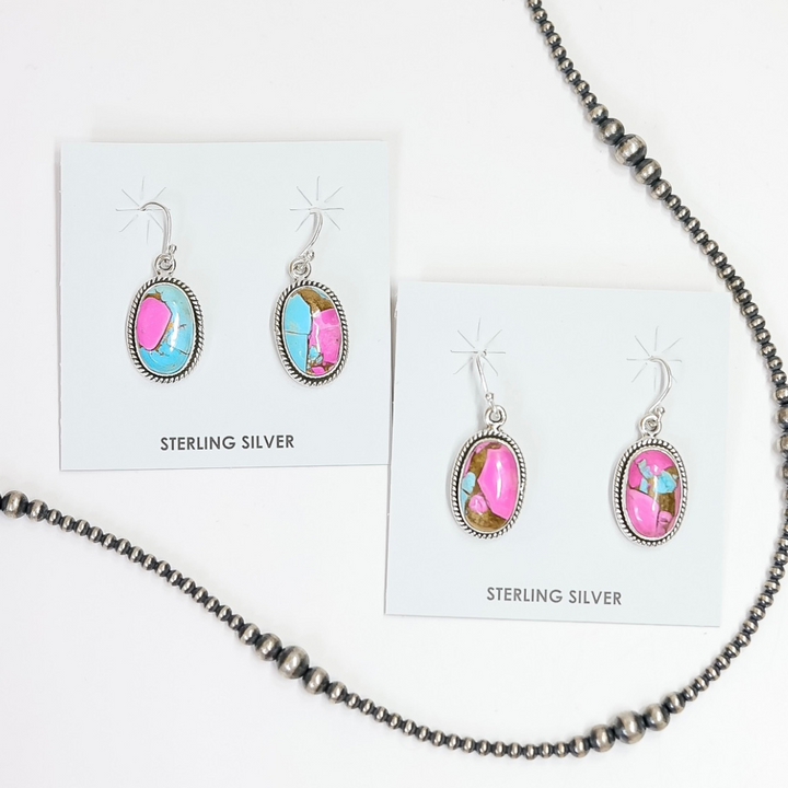 Sterling silver oval drop earrings with pink and turquoise cotton candy stones on display cards.