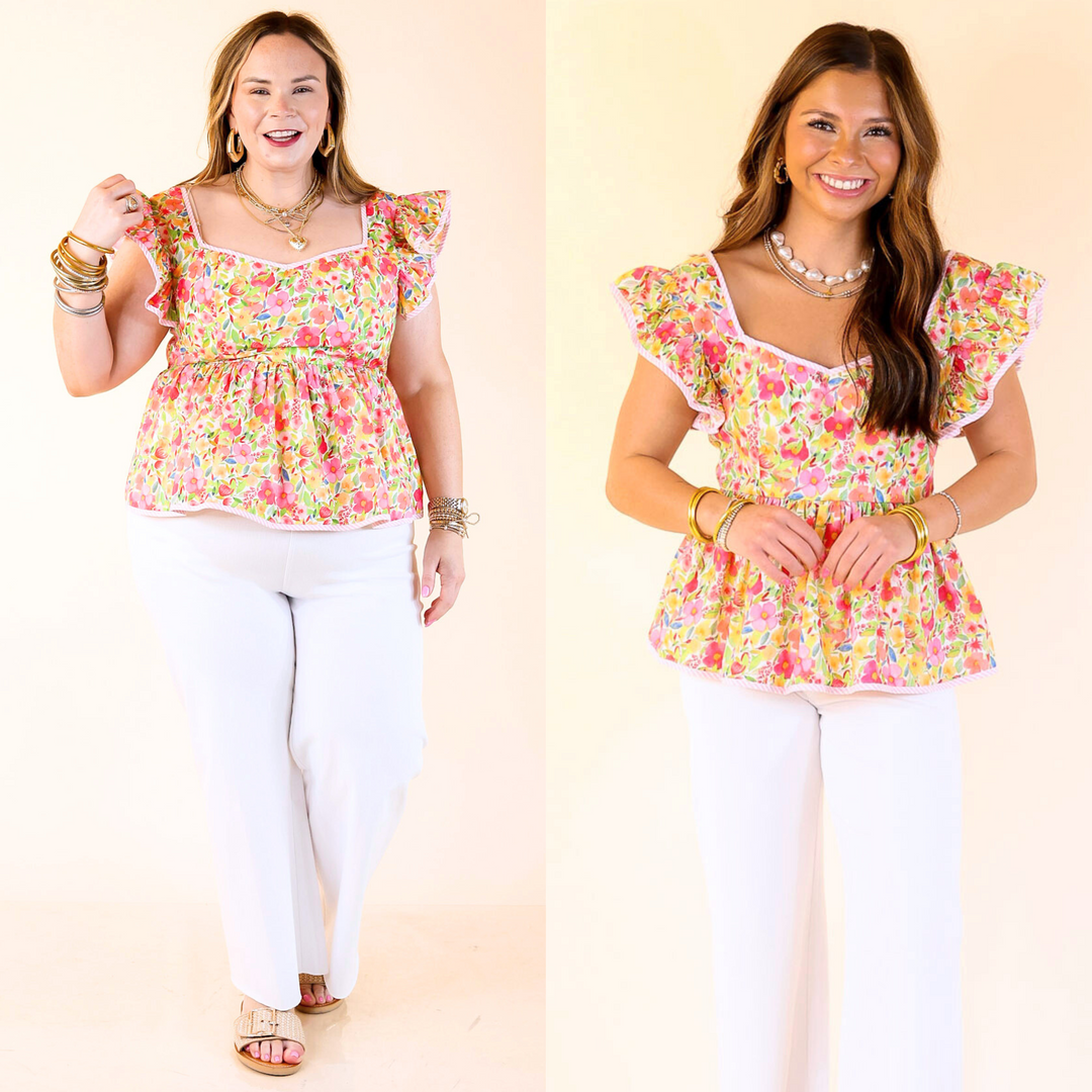 The Sugar Petals Peplum Top is flirty, floral, and full of charm. With ruffle sleeves, a pink print, and striped trim, it’s sweet and fun. Sizes small through large.