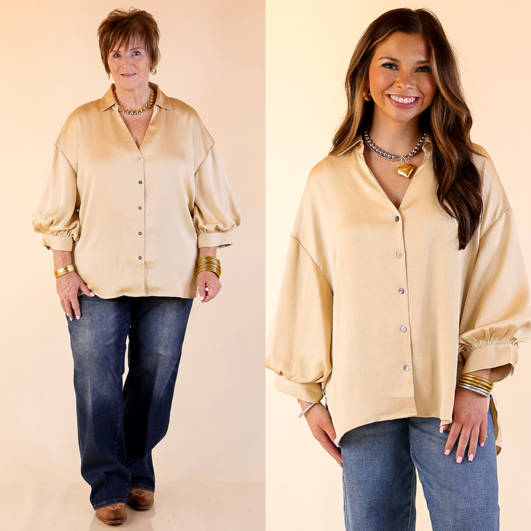 Two women wearing gold button-up top and blue jeans against a plain background