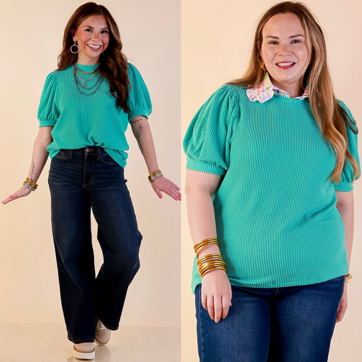 Models are wearing Puff Short Sleeve Ribbed Top with Scoop Neck in Turquoise Blue with Jeans against a beige backdrop. 