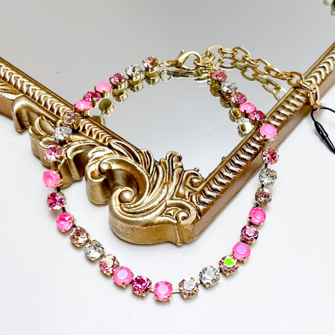 Bracelet with pink and clear beads on a decorative gold frame