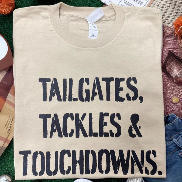 A short sleeve tee "tailgates, tackles & touchdowns" in sand