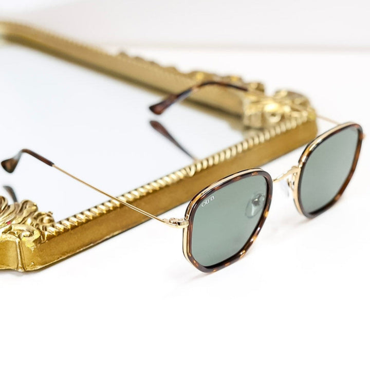Gold-framed sunglasses on a white background