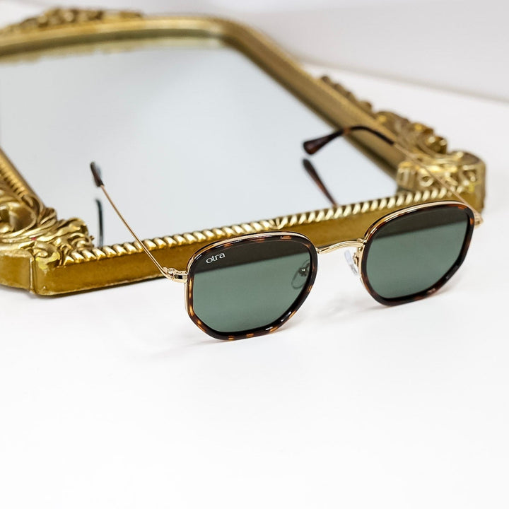 Gold-framed sunglasses on a white background