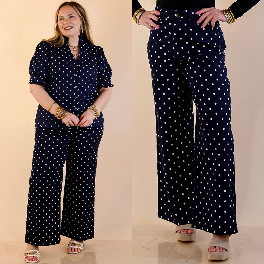 Models are wearing Wide Leg Polka Dot Denim jeans in Navy with White Dots against a beige backdrop. 