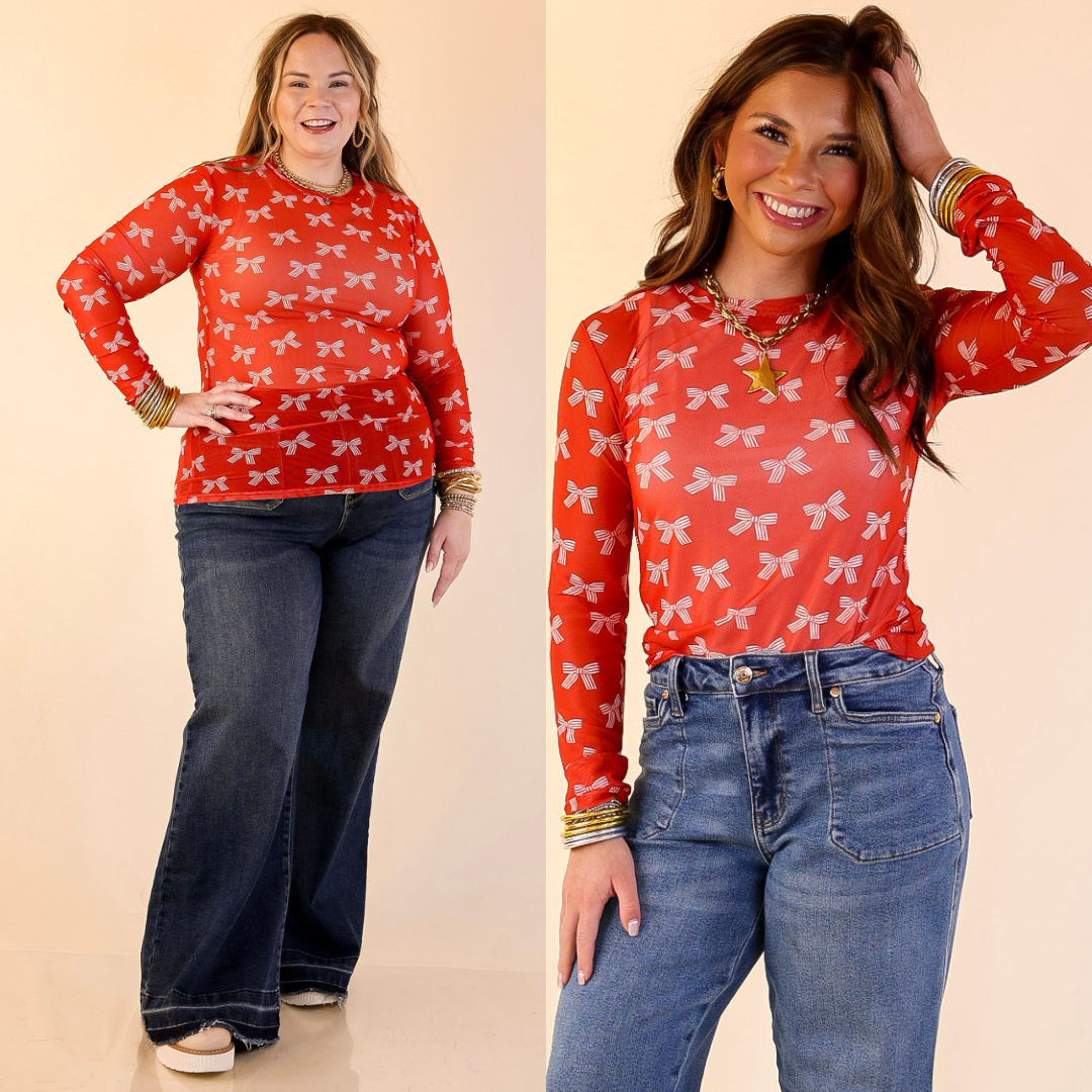 Models are wearing Bow Print Mesh Long Sleeve Top in Red and Ivory with blue jeans on a beige background