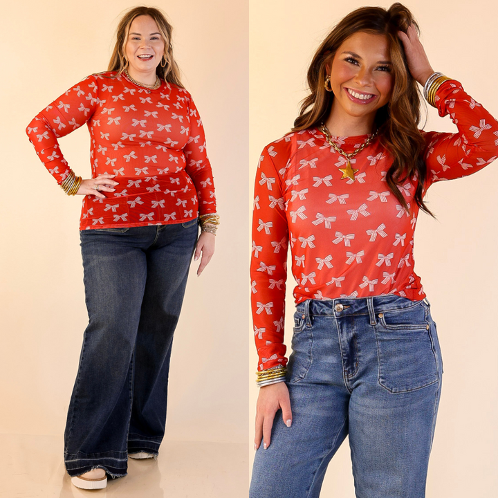 Models are wearing Bow Print Mesh Long Sleeve Top in Red and Ivory with blue jeans on a beige background