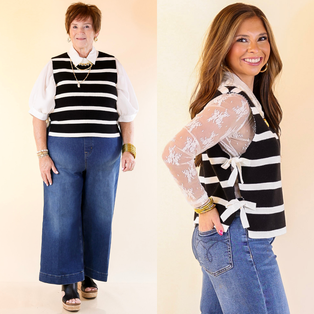 Two women wearing black and white striped vests with blue jeans on a beige background