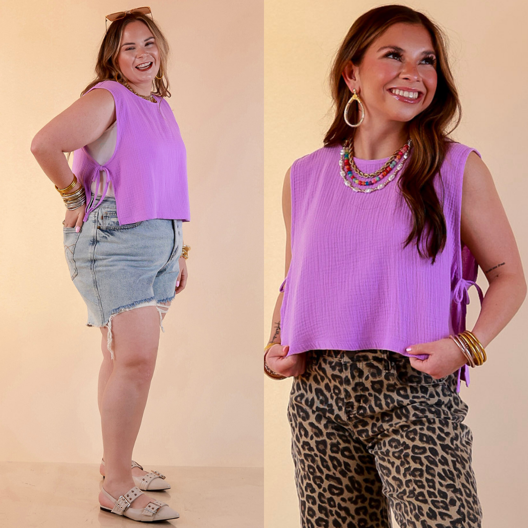 Models are wearing Sleeveless Linen Tank Top with Side Tie Detail in Lavender Purple with Jeans against a beige backdrop. 