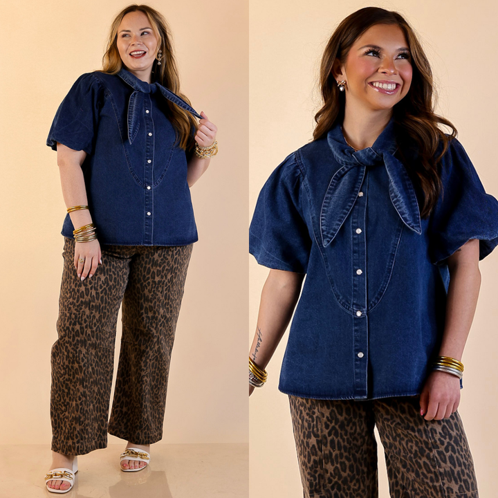 Models are wearing Pearl Snap Button Front Top with Statement Tie Neckline and Puff Sleeves in Medium Wash with jeans against a beige backdrop. 