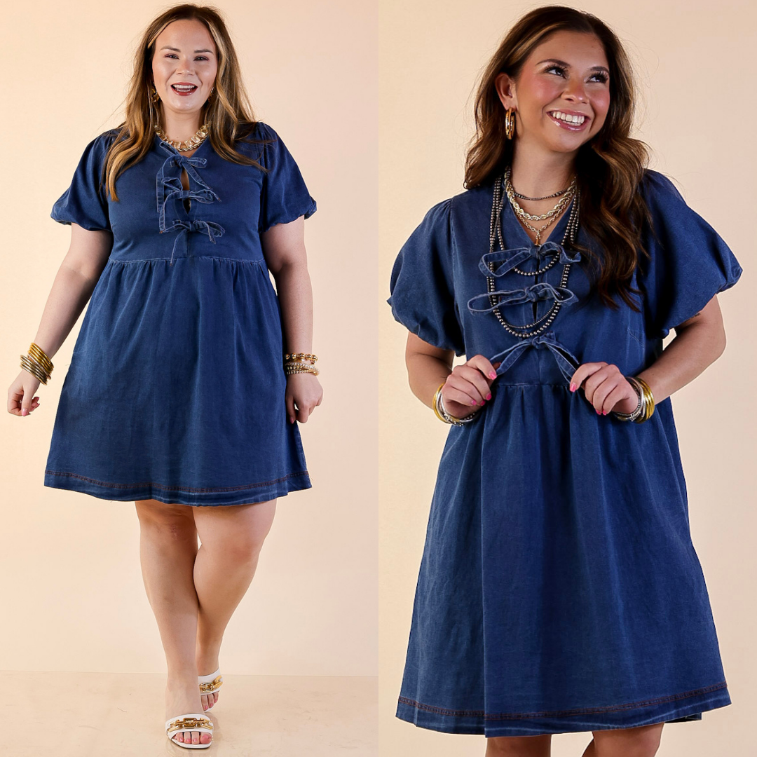 Models are wearing Short Sleeve Denim Dress with Bows in Medium Wash against a beige backdrop. 