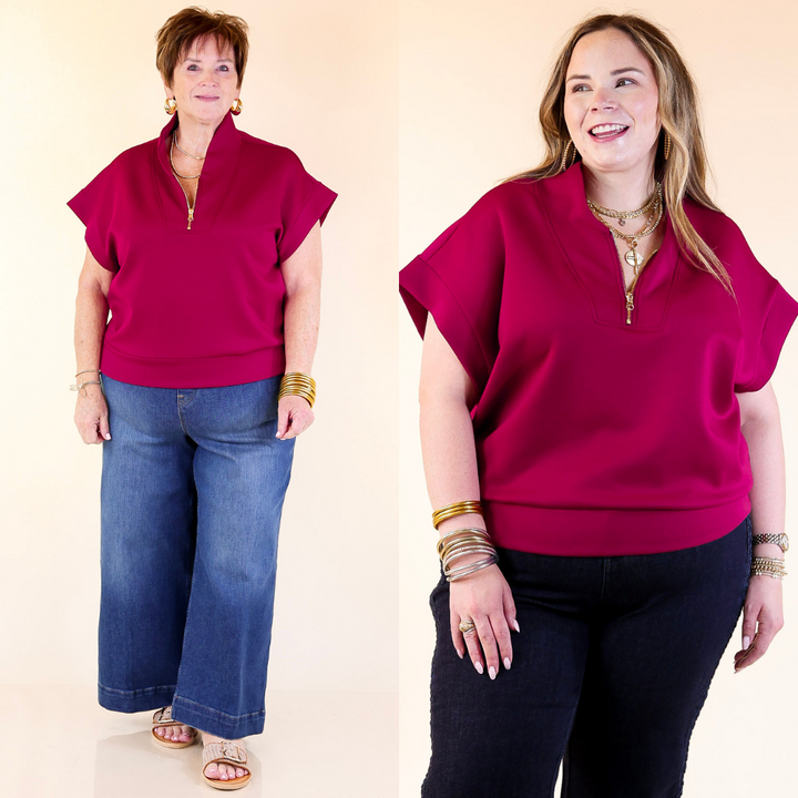 Two women wearing a Burgundy top against a plain background