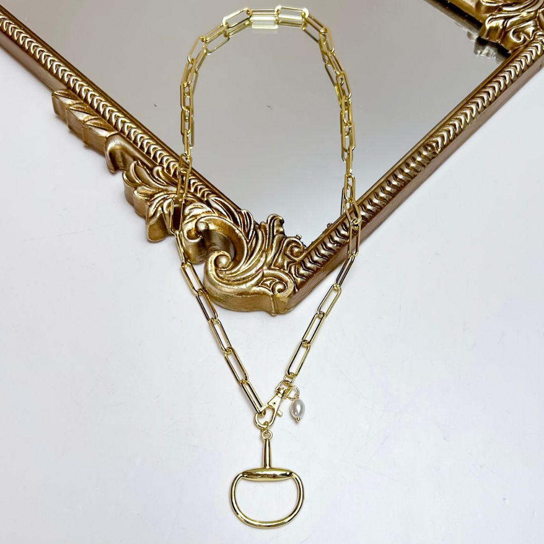 Treasure Jewels gold paperclip chain necklace featuring a polished horse bit pendant, front toggle clasp, and freshwater pearl accent charm.