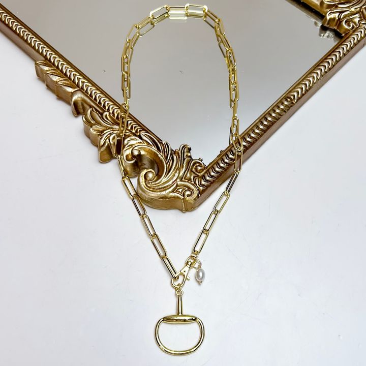 Treasure Jewels gold paperclip chain necklace featuring a polished horse bit pendant, front toggle clasp, and freshwater pearl accent charm.