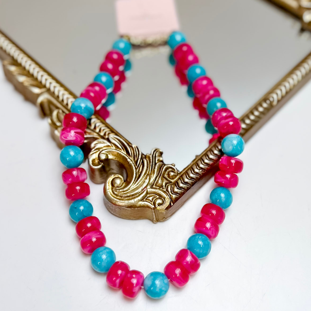 Treasure Jewels Fiesta Pop beaded necklace featuring vibrant hot pink rondelle beads and glossy turquoise blue round beads with an adjustable chain.