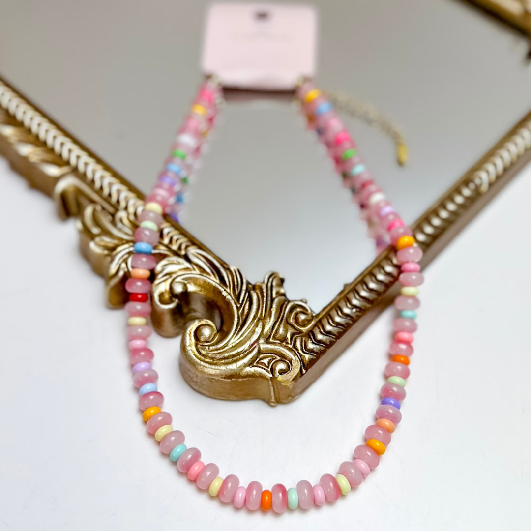Treasure Jewels multicolor beaded necklace featuring blush pink beads with pastel blue, mint, lavender, yellow, coral, orange, and hot pink accents.