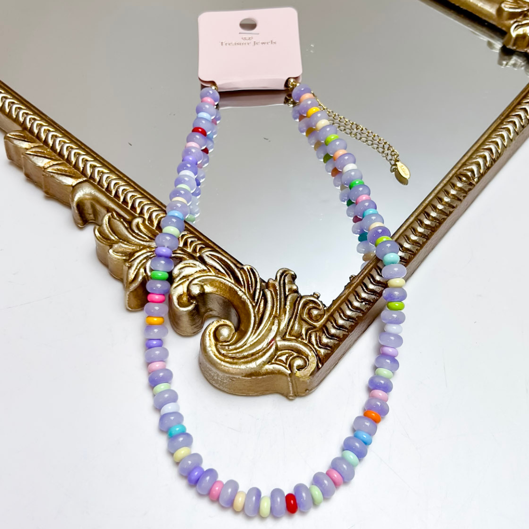 Treasure Jewels lavender beaded necklace featuring colorful rainbow accent beads and an adjustable gold chain extension.