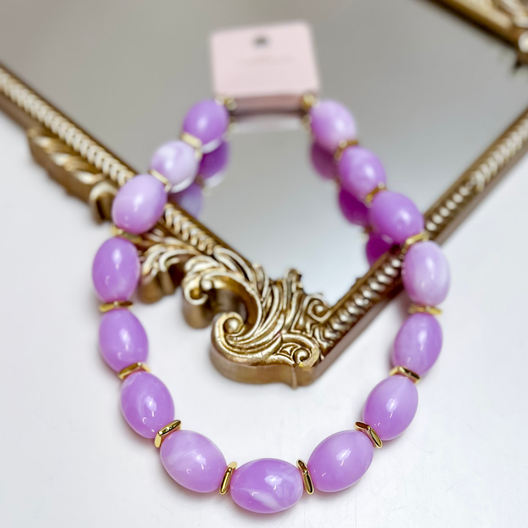 Treasure Jewels lavender oval beaded necklace featuring glossy marbled beads with polished gold spacer accents and an adjustable chain extension.