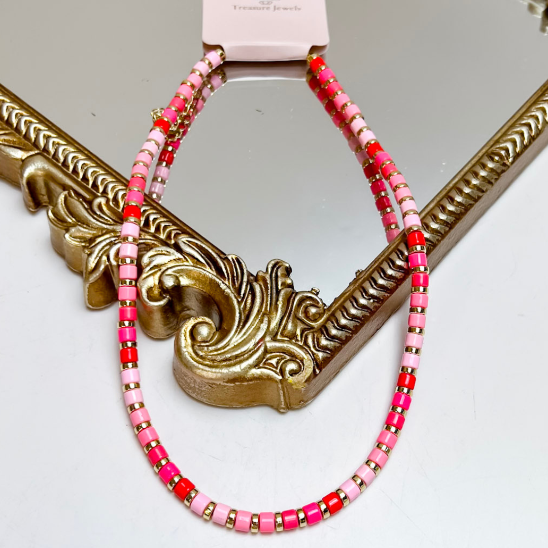 Treasure Jewels pink tile beaded necklace featuring shades of blush, hot pink, coral red, and gold spacer beads.