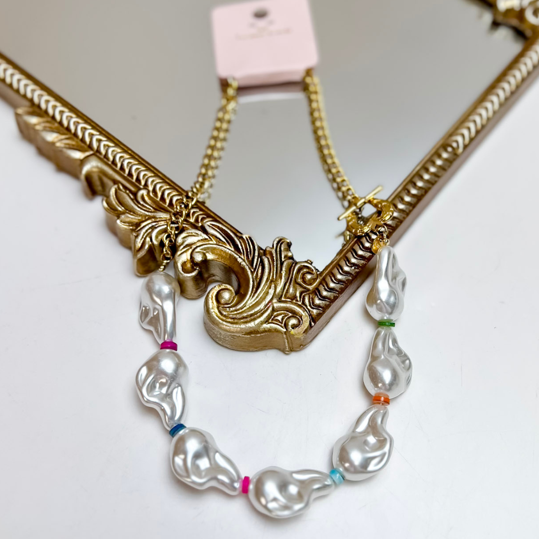 Treasure Jewels gold chain necklace featuring irregular faux pearl beads with colorful rainbow spacer accents and a toggle clasp.