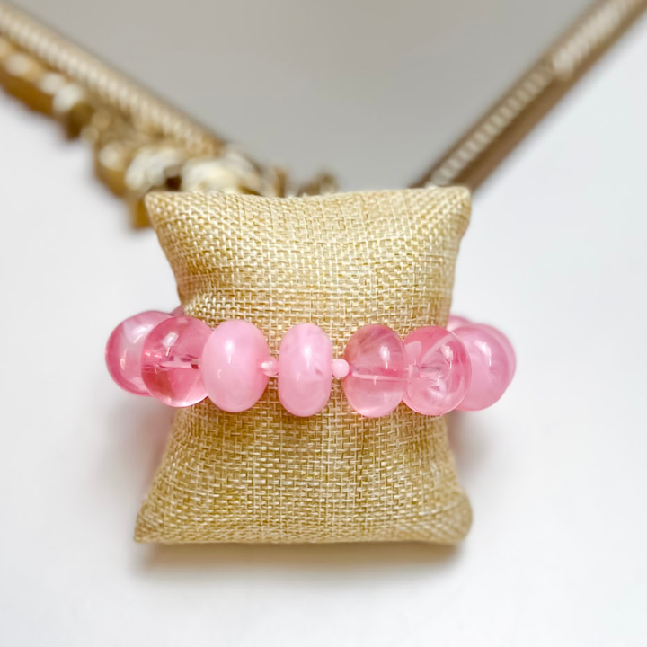 Treasure Jewels stretch bracelet featuring glossy translucent light pink rounded beads.