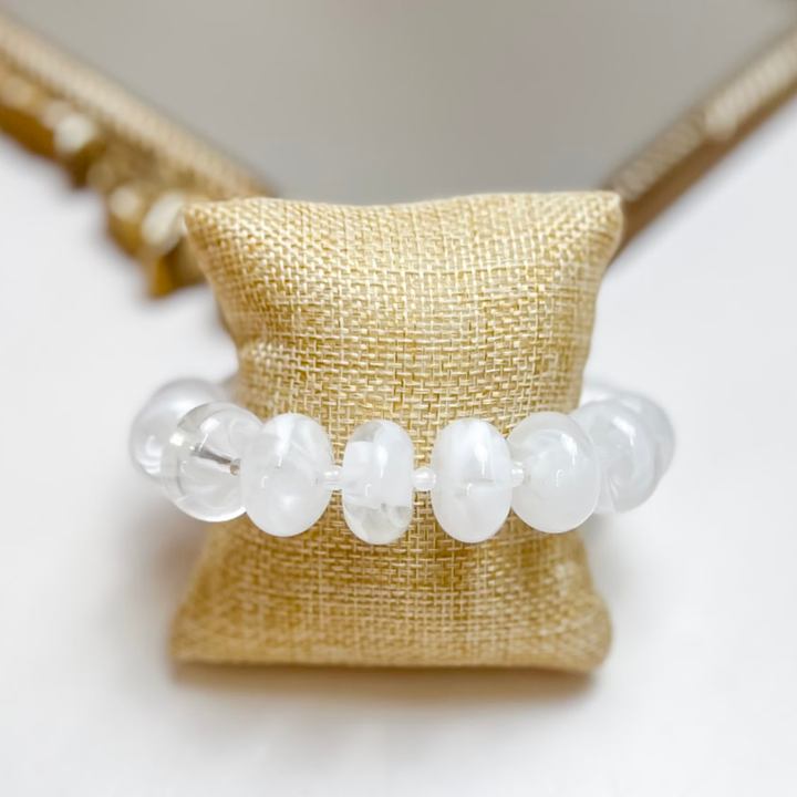 Treasure Jewels stretch bracelet featuring glossy white translucent rounded beads.