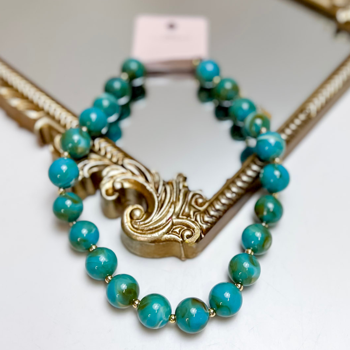 Treasure Jewels blue round beaded necklace featuring glossy turquoise and aqua beads with gold spacer accents.