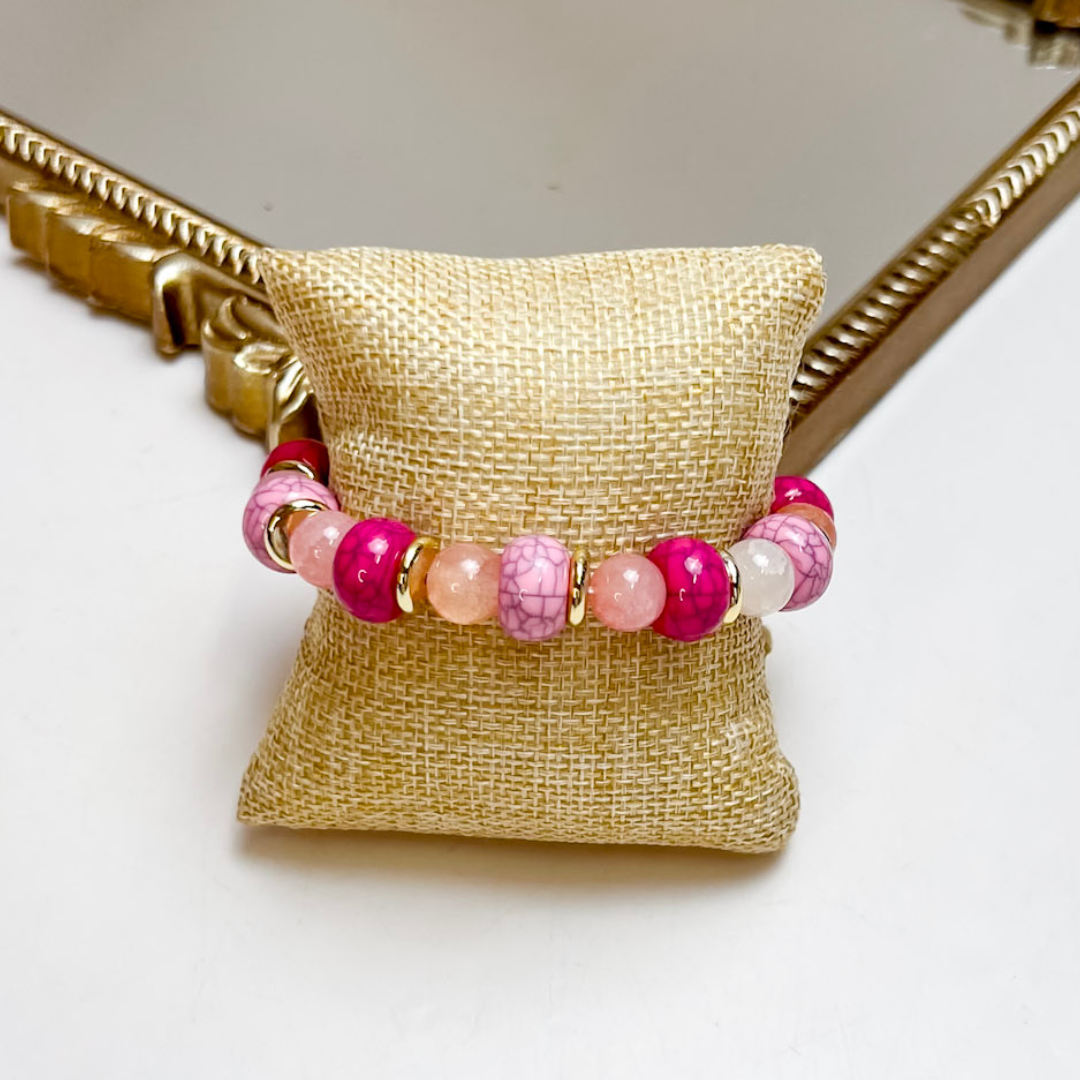Treasure Jewels stretch bracelet featuring pink marbled beads, blush crystal accents, white beads, and gold spacer details.