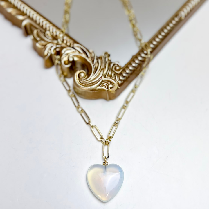 Treasure Jewels gold paperclip chain necklace featuring a glossy white heart pendant.