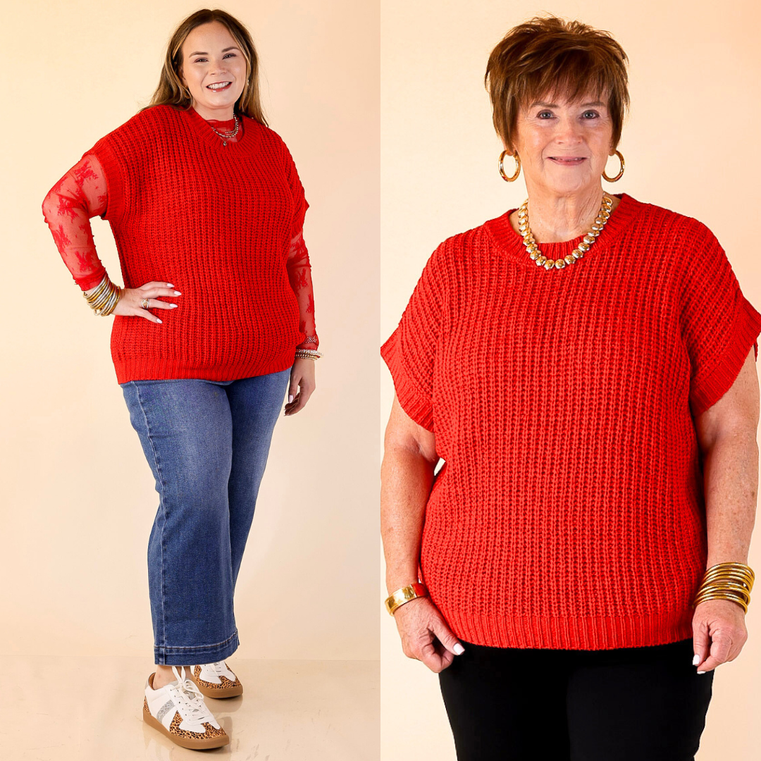Two women wearing red oversized sweaters on a beige background
