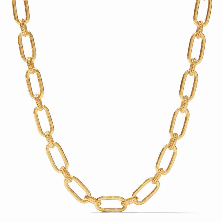 Pictured is a gold, hammered chain link necklace pictured on a white background. 