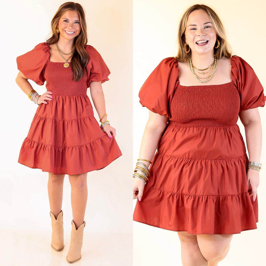 Two women wearing a Rust Orange dress with puff sleeves against a white background