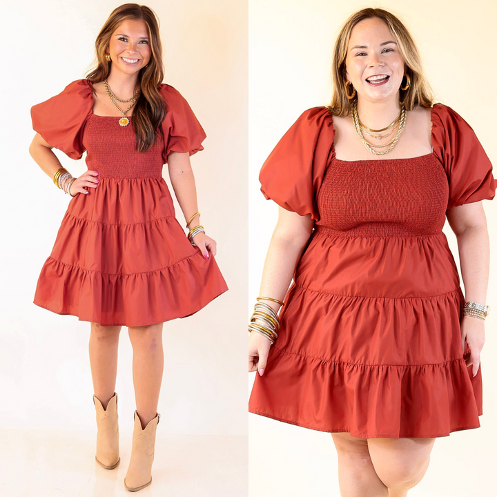 Two women wearing a Rust Orange dress with puff sleeves against a white background