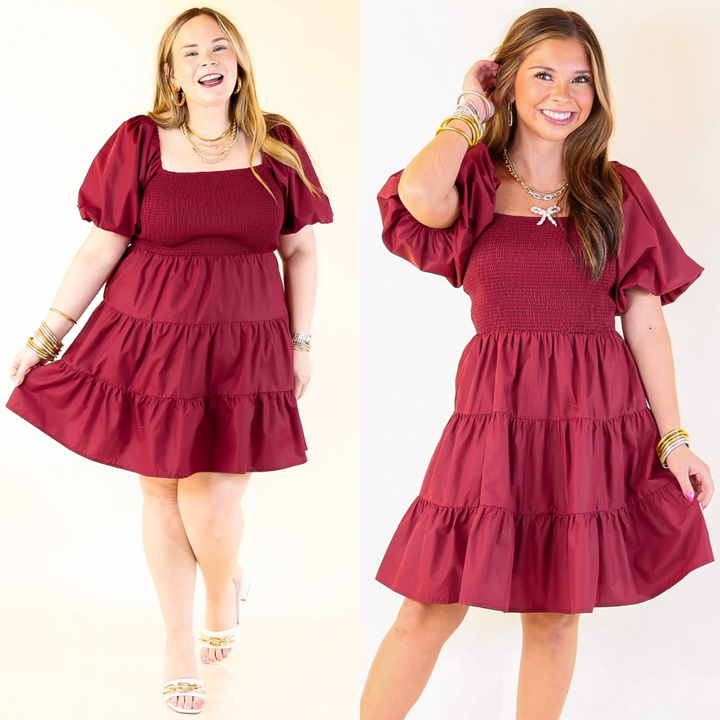 Two images of a woman wearing a burgundy dress with ruffled sleeves and layered skirt on a white background.