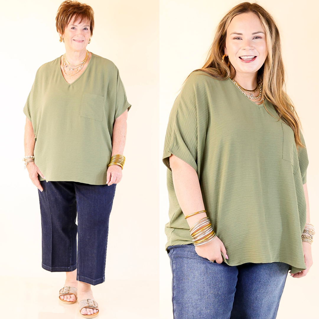 Two women wearing olive green tops and blue jeans on a beige background