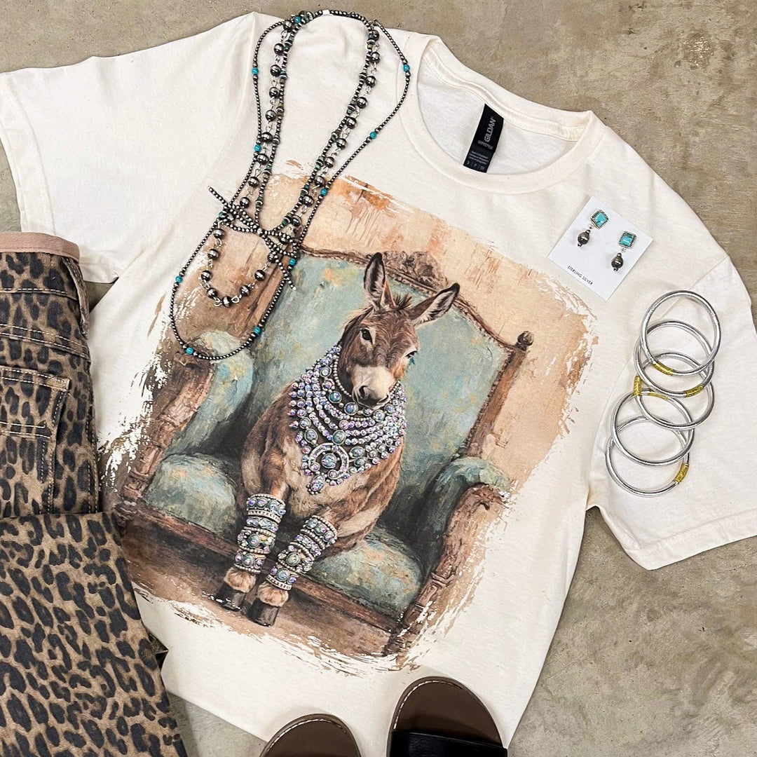 T-shirt with animal print design, leopard print shorts, and black slides on a concrete surface