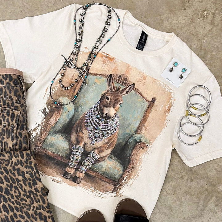 T-shirt with animal print design, leopard print shorts, and black slides on a concrete surface