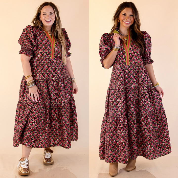 Woman wearing a floral patterned dress in black on a plain background