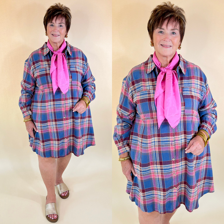 Woman wearing a blue plaid dress with a pink scarf against a beige background