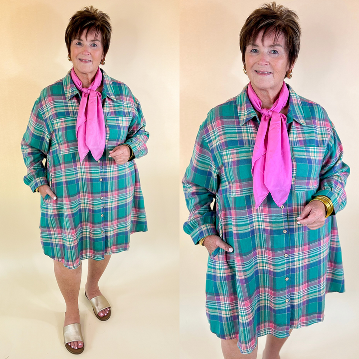 Woman wearing a teal plaid dress with pink accents and a pink scarf against a beige background
