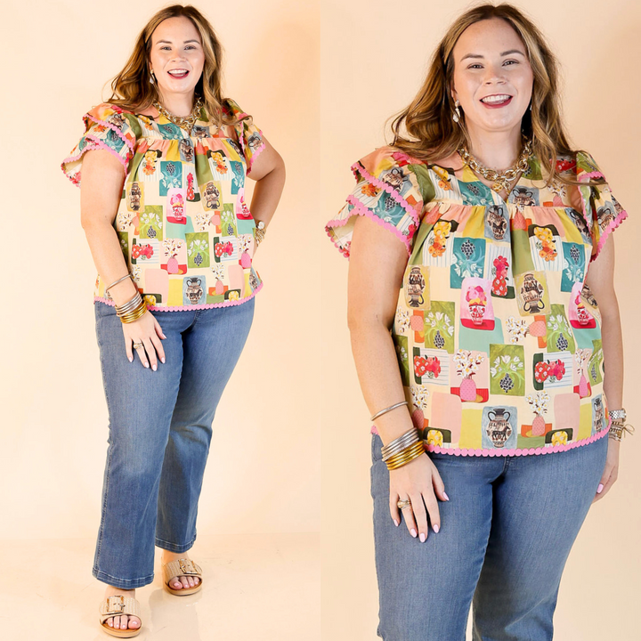 This top features a multicolor abstract floral print, a v neck, and tiered ruffle cap sleeves with pink detailing.