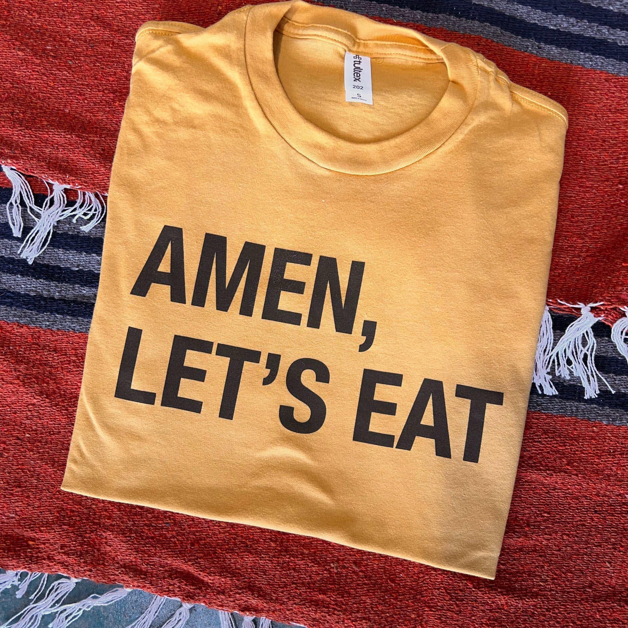 Online Exclusive | Amen, Let's Eat Short Sleeve Graphic Tee in Mustard Yellow - Giddy Up Glamour Boutique