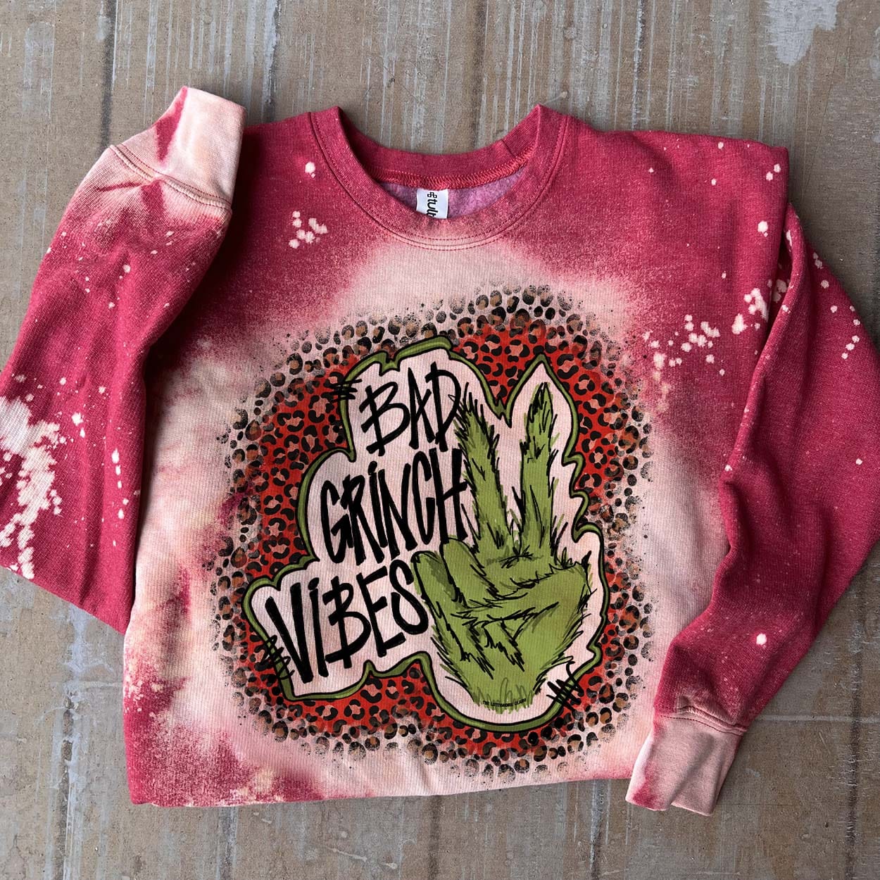 Online Exclusive | Bad Grinch Vibes Long Sleeve Bleached Splatter Graphic Sweatshirt in Red - Giddy Up Glamour Boutique