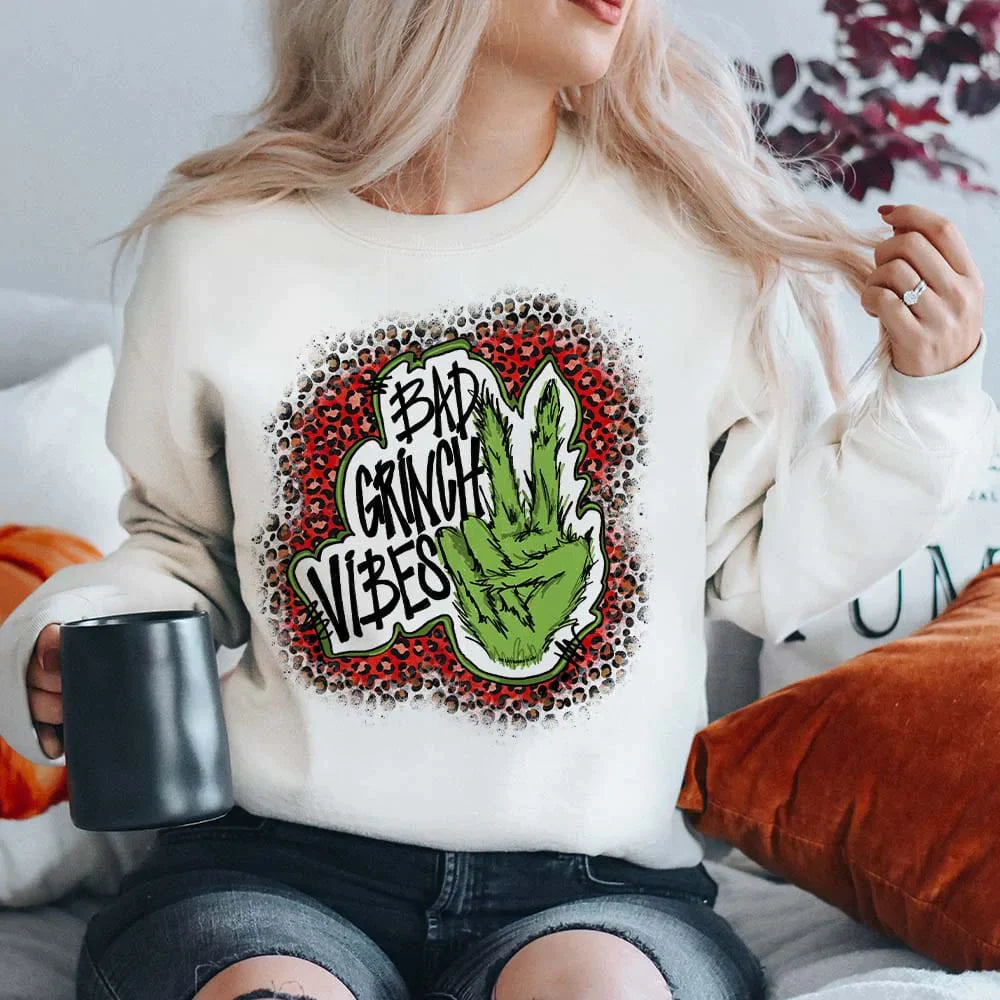 Online Exclusive | Bad Grinch Vibes Long Sleeve Graphic Fleece Sweatshirt in White - Giddy Up Glamour Boutique