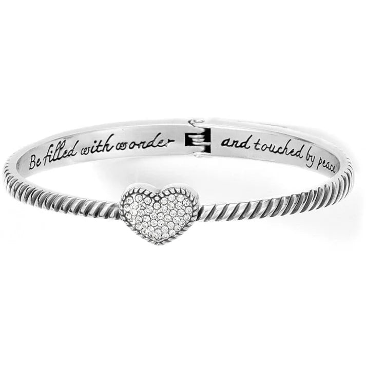 Silver bracelet with heart charm and engraved text on a white background