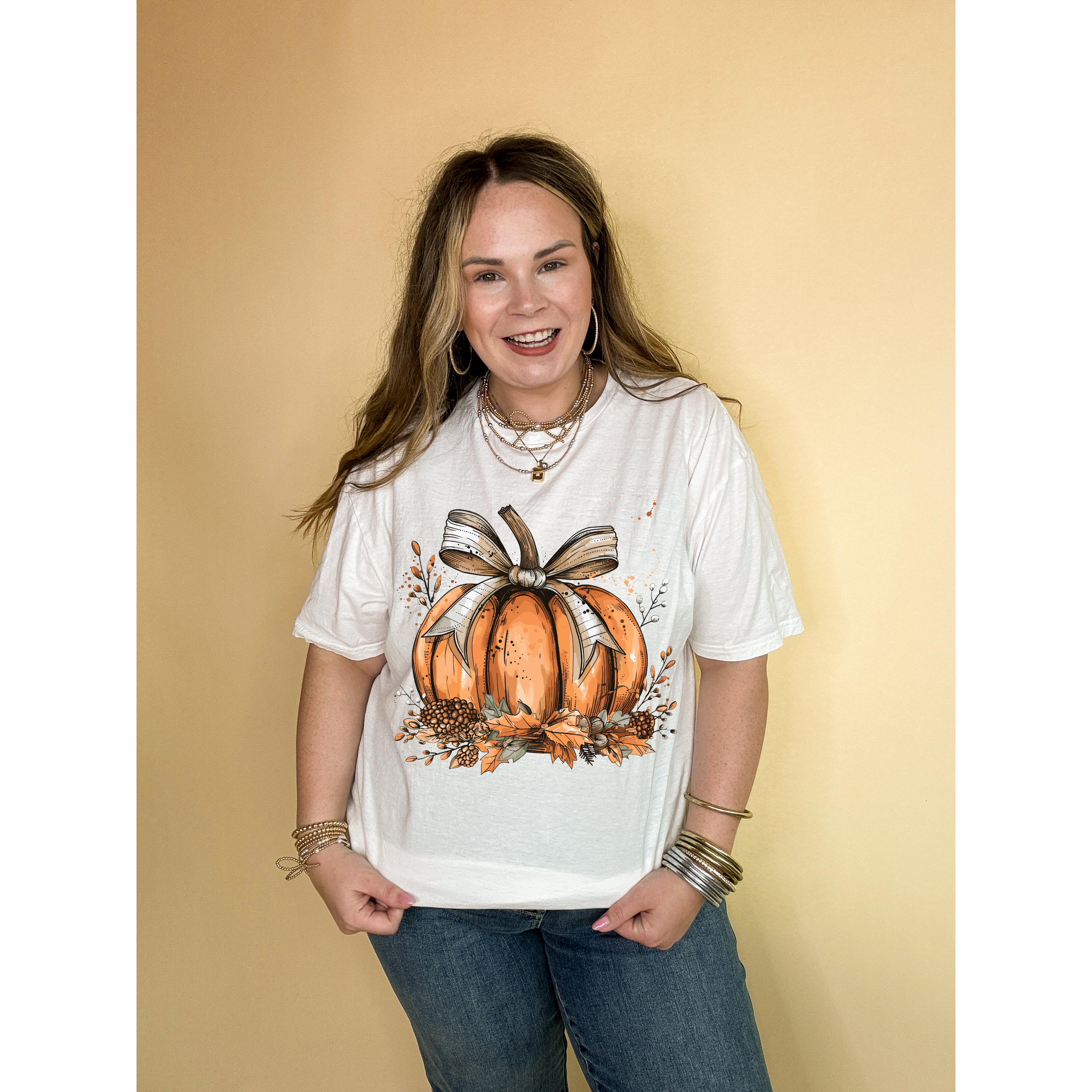 Online Exclusive | Chic Autumn Pumpkin on a Bed of Leaves with White Bow Graphic Tee in Multiple Color Options